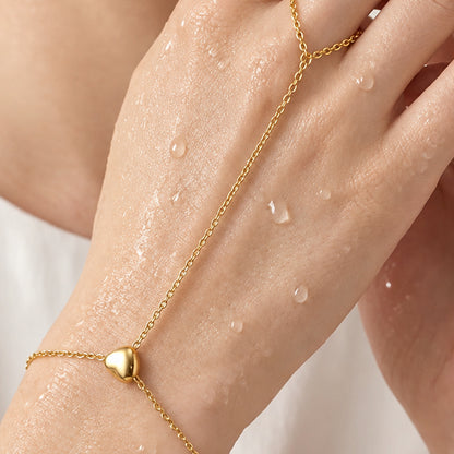 Cora Hand Chain – model wearing gold heart hand chain