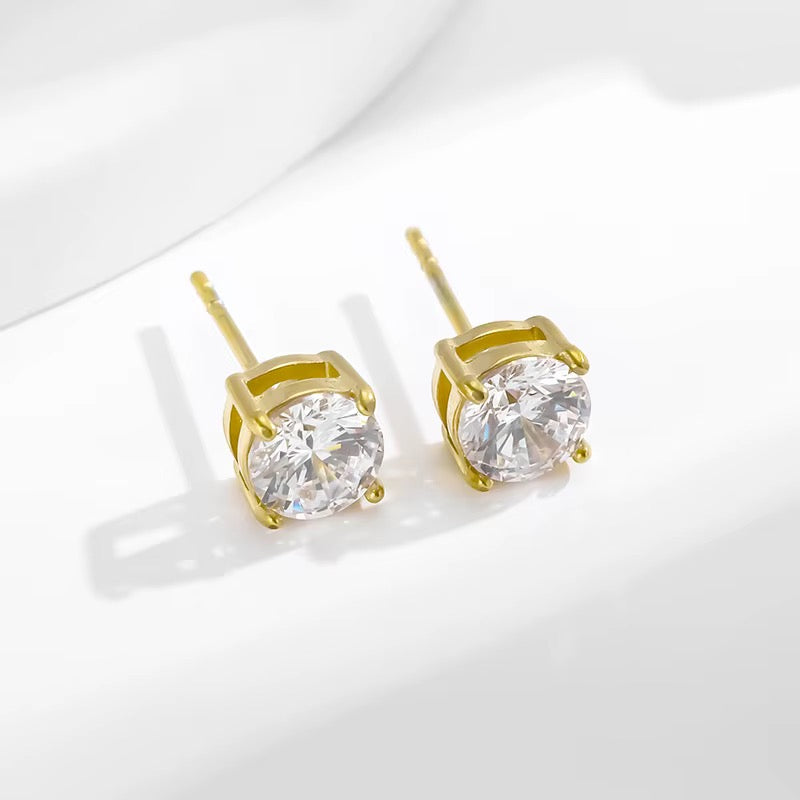 Pair of gold-plated stud earrings with clear round stones